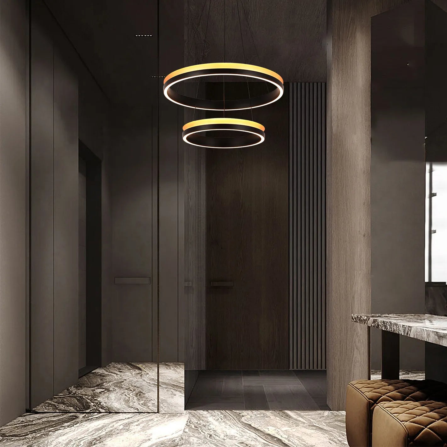 A pair of stylish circular pendant lights hang in a modern hallway, casting a warm glow.