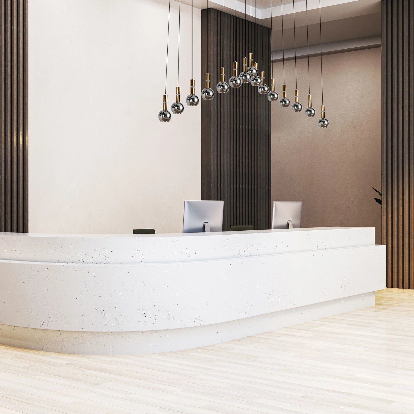 An eye-catching modern light feature with chrome orbs hangs over a sleek reception desk, adding a touch of glamour to the room.