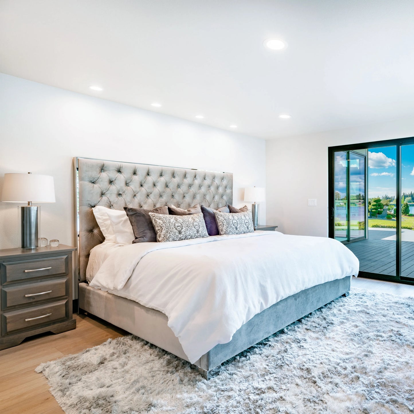 Bright bedroom with ample downlighting and lamps. A well-lit space showcasing modern lighting for a luxurious feel.