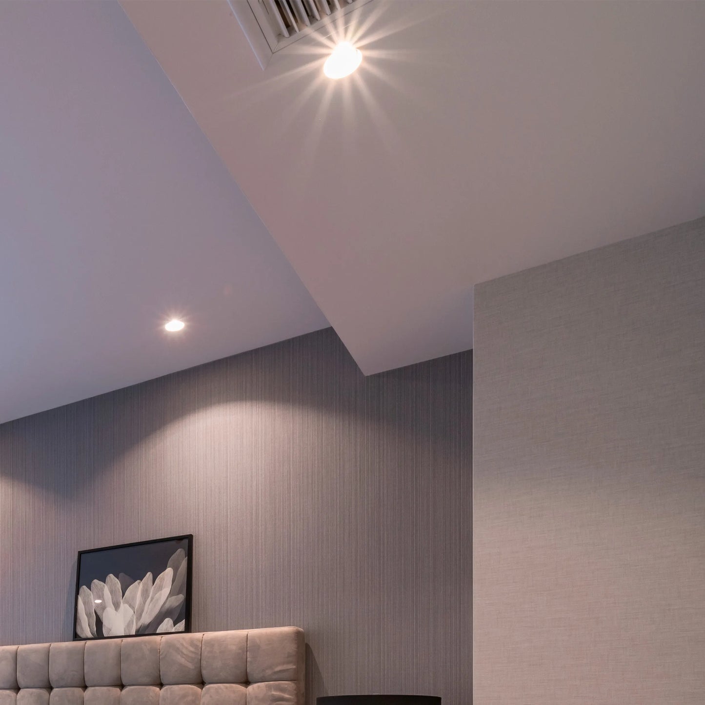 Recessed spotlights provide focused illumination, highlighting the room's architectural details and creating a soft, ambient glow.
