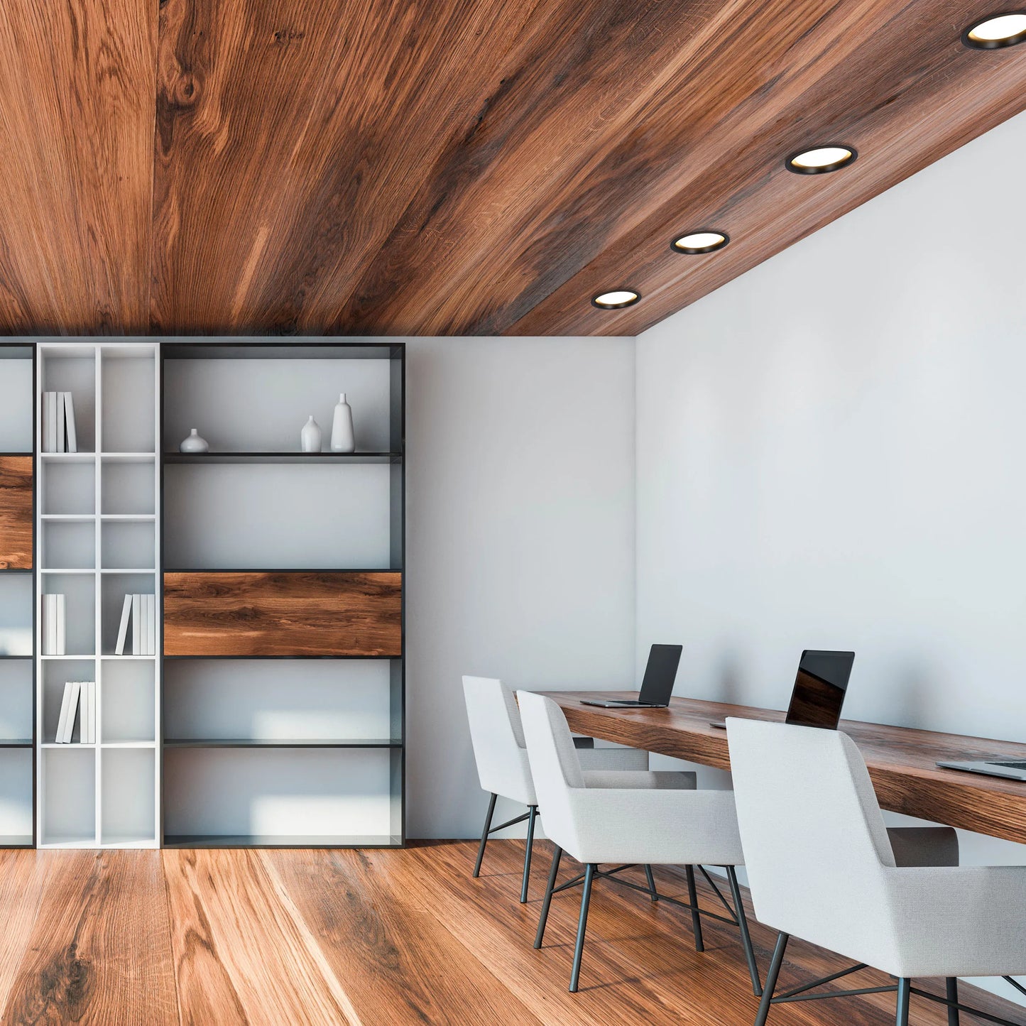 A row of sleek, recessed spotlights illuminate the room. The lighting reflects off the wood ceiling, creating a warm ambience.