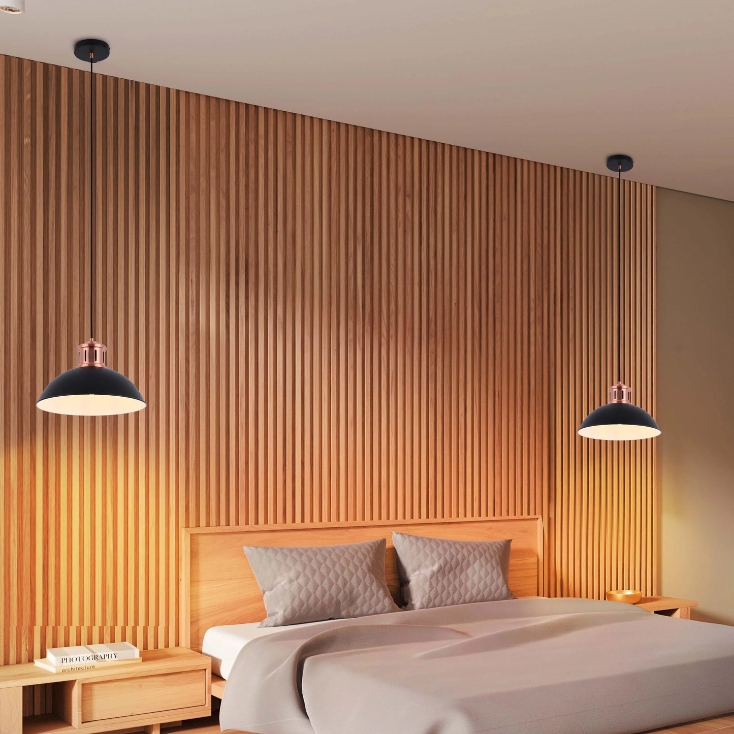 Two pendant lights with black shades and copper accents illuminate a bedroom with wooden panelling.