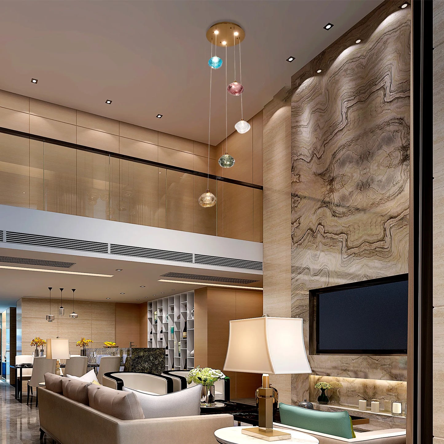 A modern living room featuring a cluster of pendant lights with colourful glass shades, and soft recessed lighting.