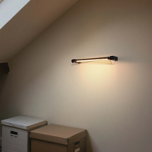 Stylish wall sconce with a gold mesh shade, emitting a warm glow. Modern design meets practical illumination.