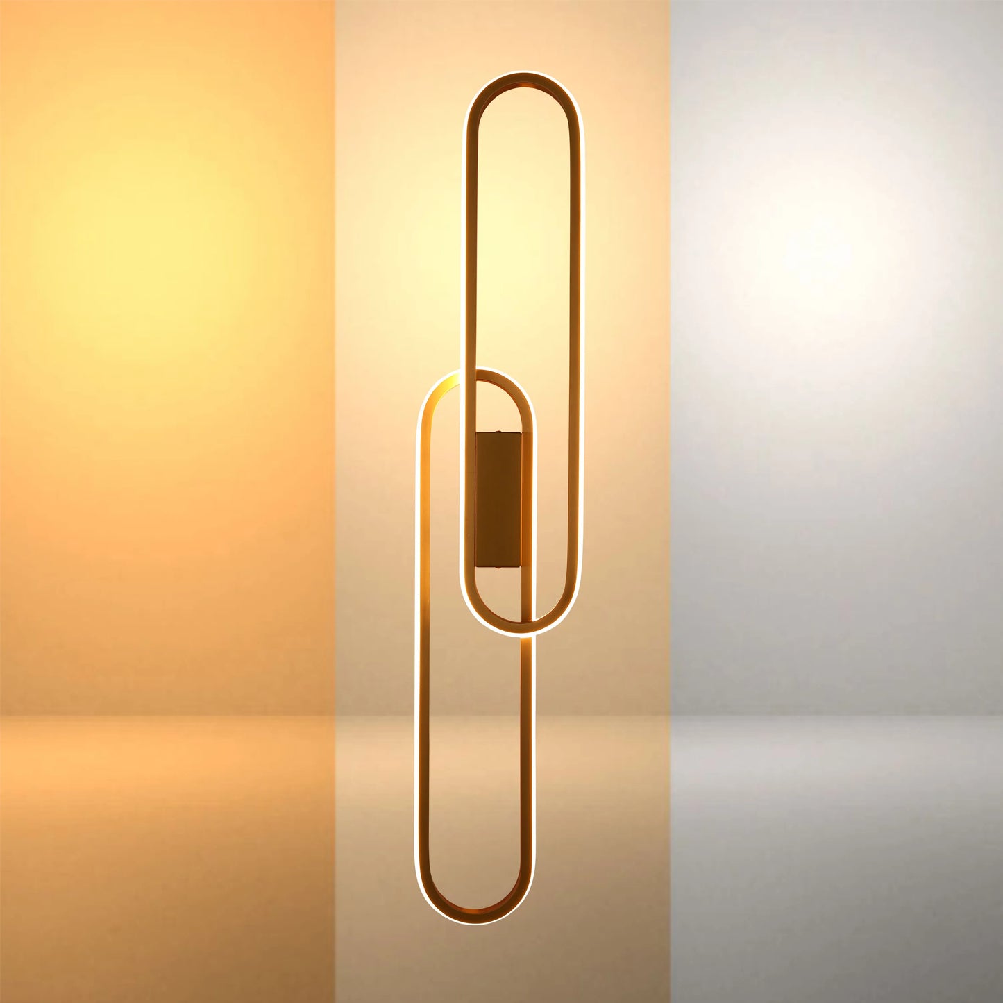 A modern wall light with interconnected gold ovals illuminated by LED strip lights. The lighting is warm and inviting.