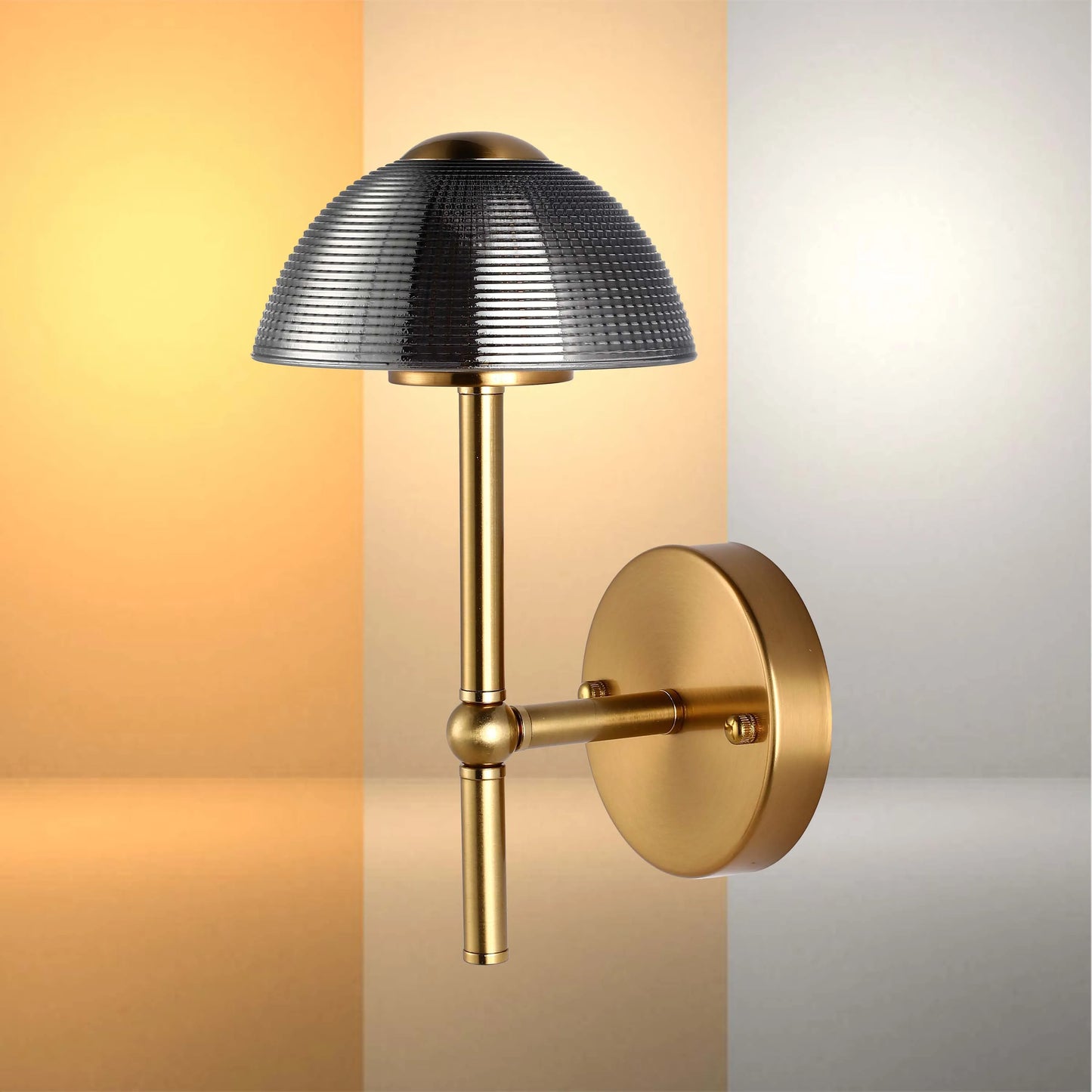 Modern brass wall light with a textured grey lampshade. Provides a warm, ambient glow.