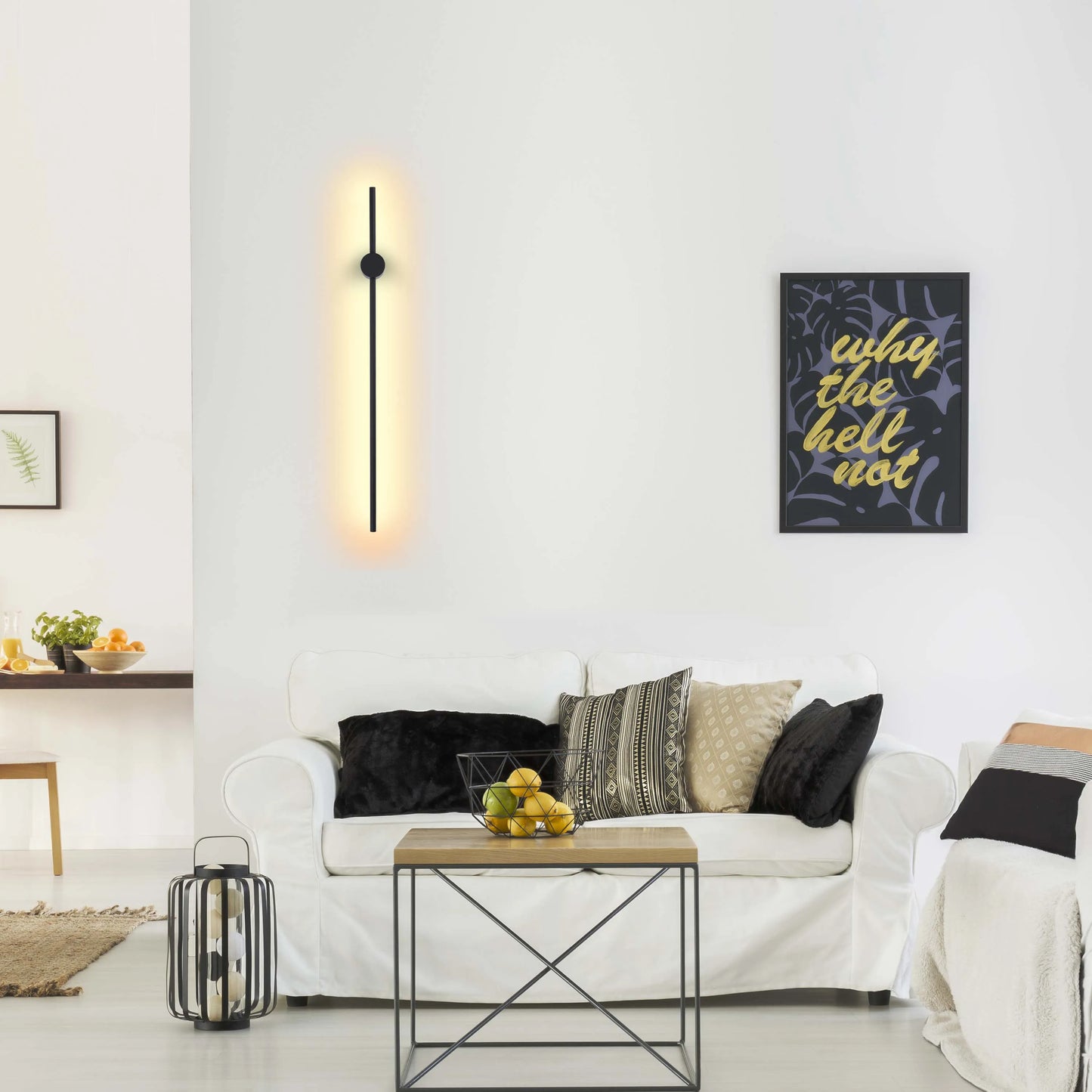 A modern wall light with a sleek black design and a warm, diffused glow, creating a stylish accent in this bright living room.