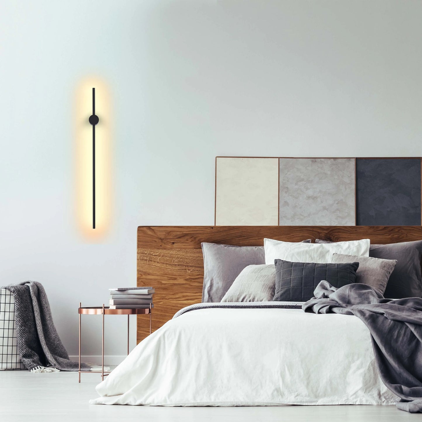 Modern, slimline black wall light providing a warm glow. Minimalist design for contemporary interior spaces.