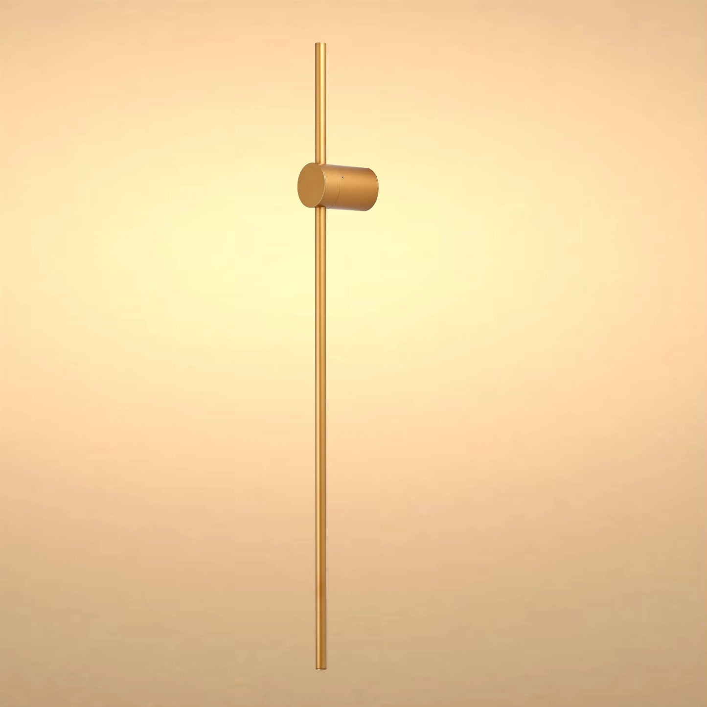 Minimalist gold wall light with cylindrical shade and slim linear stem, perfect for modern homes.