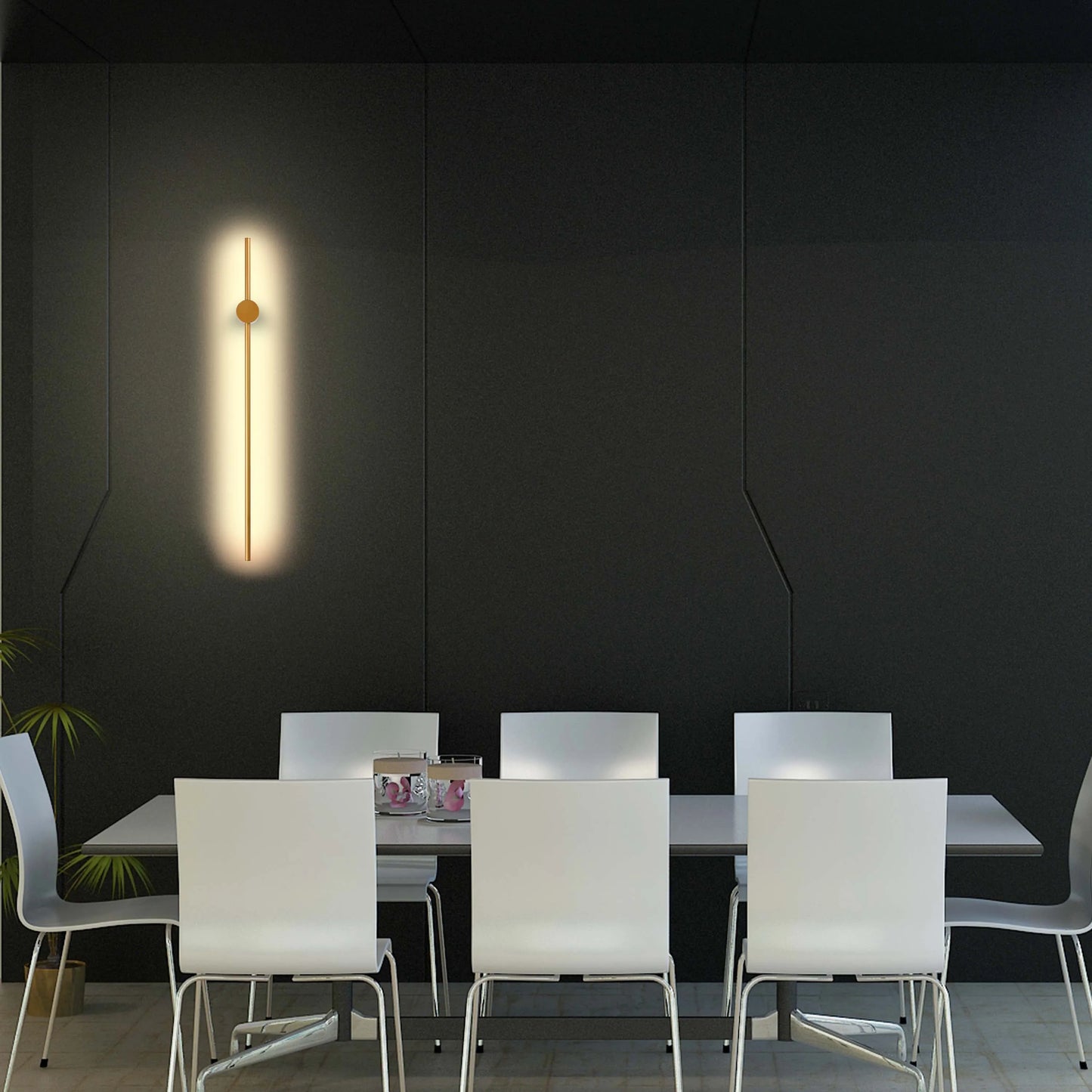 A slim, vertical wall light with a brass centre detail casts a warm glow against the dark wall. Contemporary and stylish lighting.
