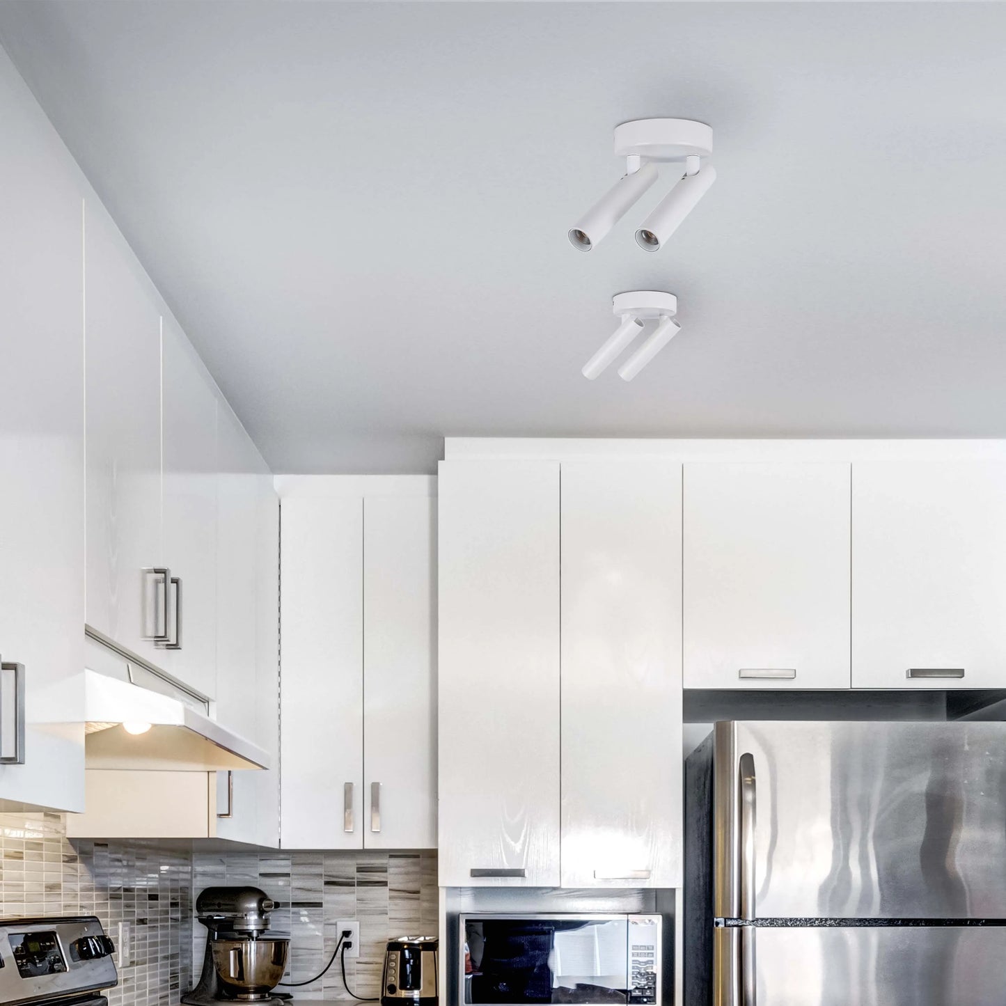 Modern kitchen spotlights. Two ceiling-mounted, adjustable fixtures provide directed light in a sleek white finish.