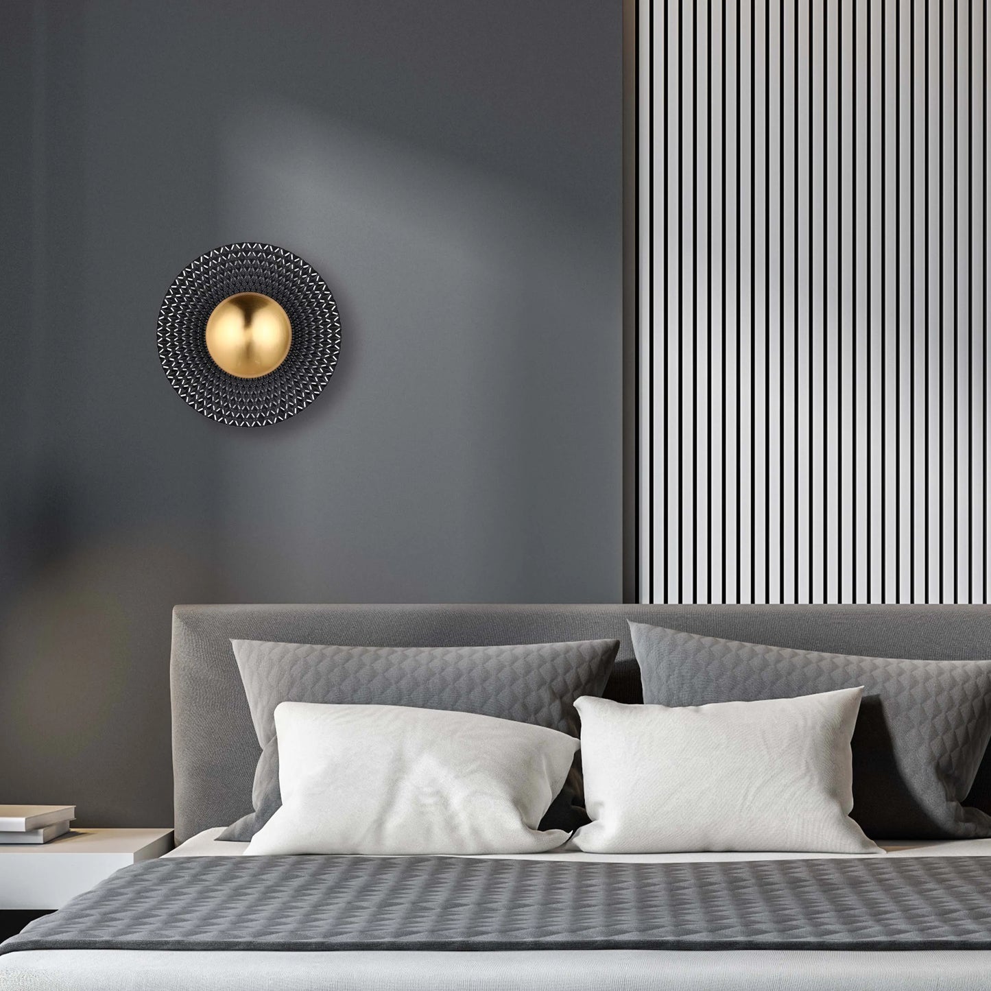 A modern wall light features a central gold sphere surrounded by a geometric, textured disc, adding a touch of contemporary elegance.