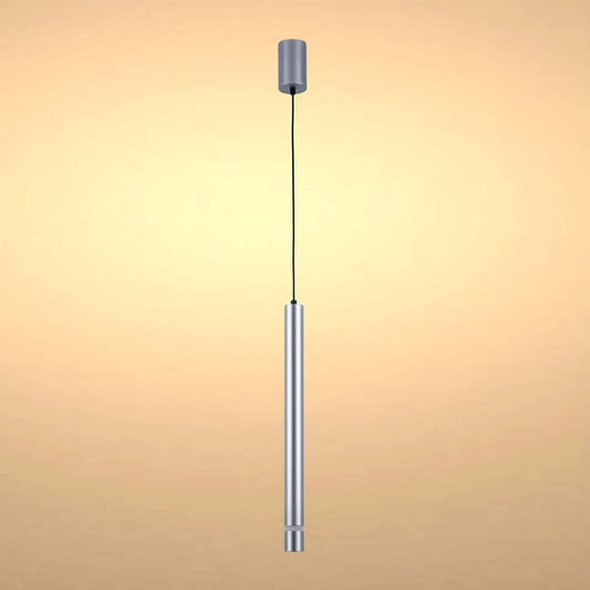 A cylindrical, silver pendant light hangs from a black cable, softly lit against a warm, neutral background.