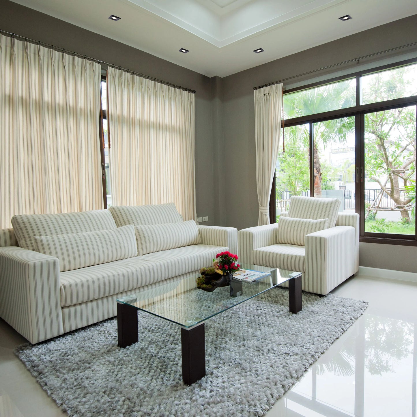 Recessed downlights provide ambient lighting in this living room, creating a bright and modern space.