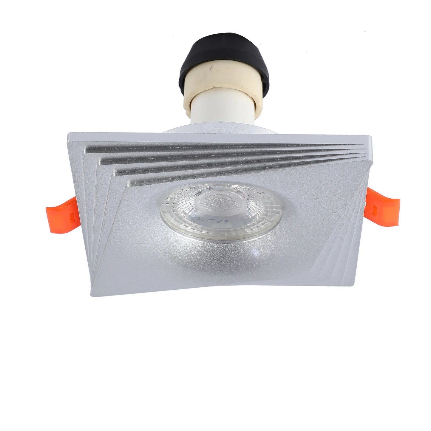 Square silver downlight with a refractive lens, emitting bright, even light. Has orange spring clips for easy installation.