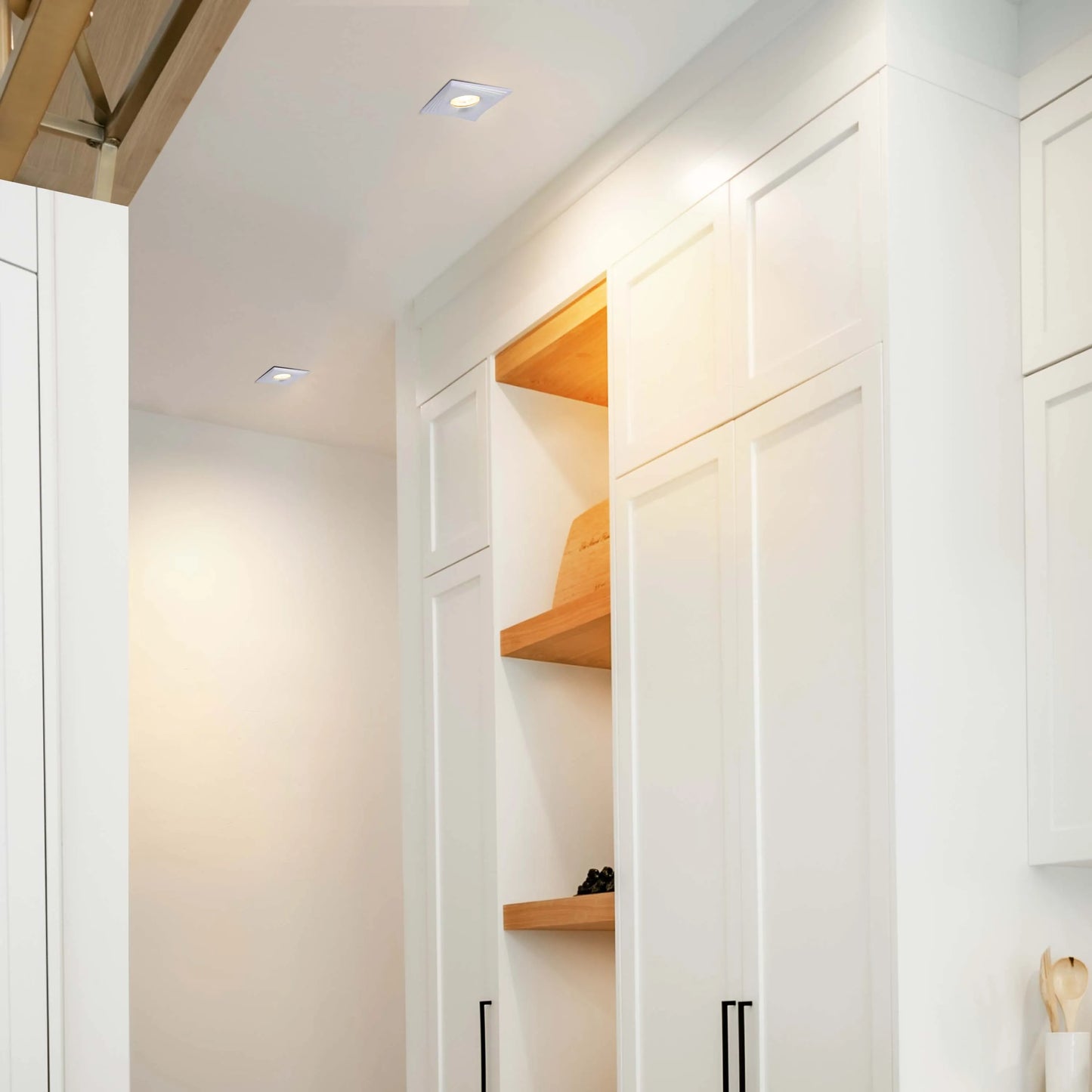 Modern kitchen with sleek, recessed lighting. Square downlights are flush with the ceiling, providing bright, even illumination.