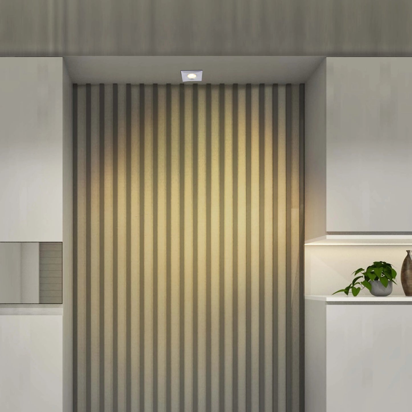 A minimalist, square downlight provides a central focus, contrasting with the subtle under-cabinet lighting and sleek, modern design.