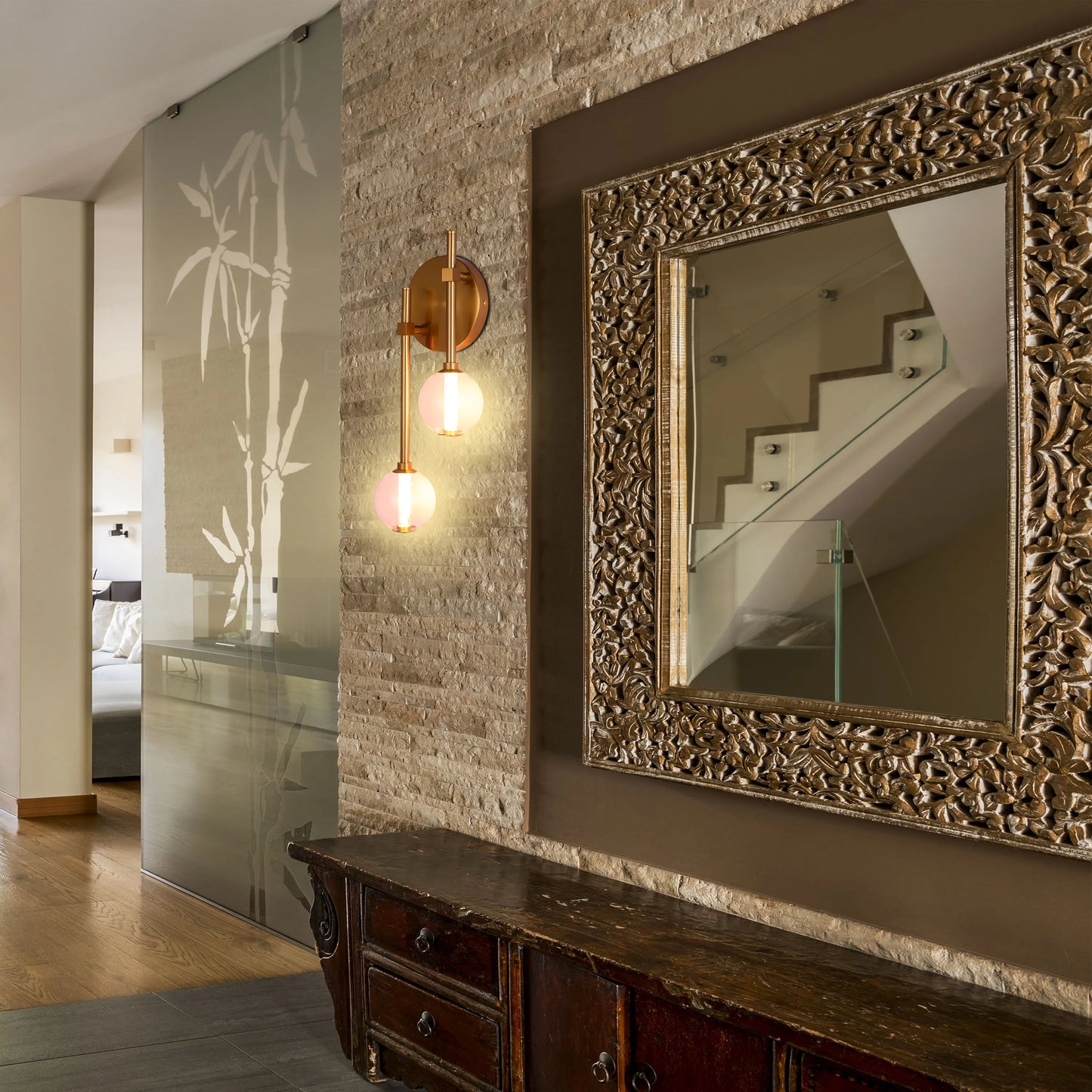 A sconce with two round lights illuminates a hallway, adding a touch of warmth and elegance to the wall decor.