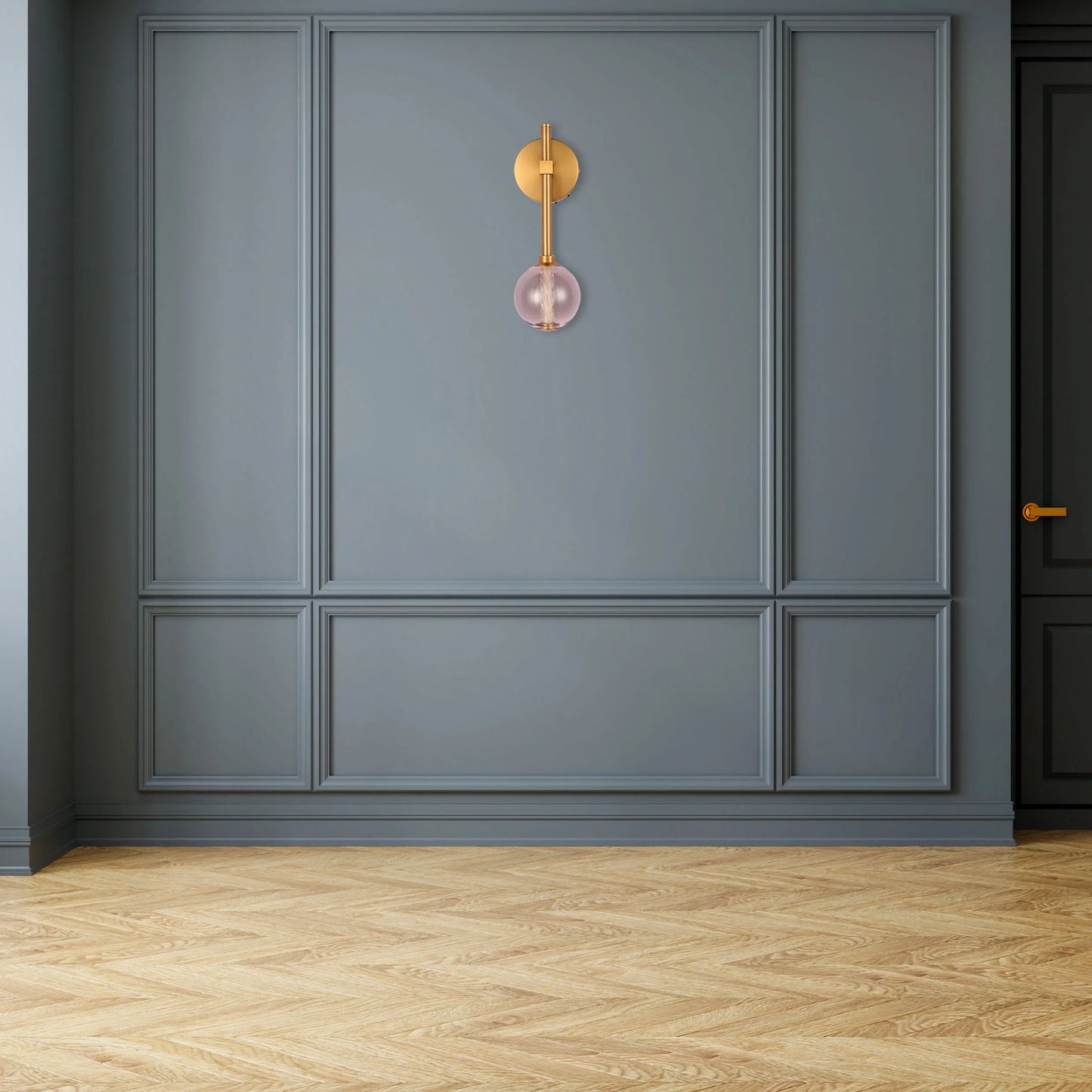 A contemporary wall light with a brass fixture and pink glass globe, adding a touch of elegance to the room's decor.