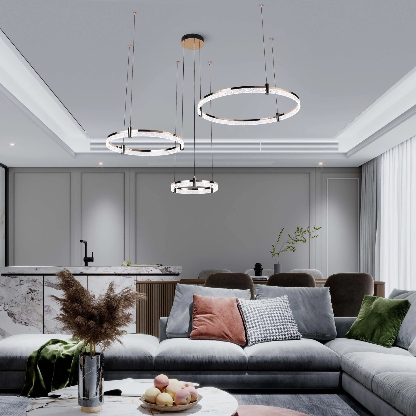 Contemporary ring pendant lights hanging above a living and dining space, creating a luxurious and modern ambience.