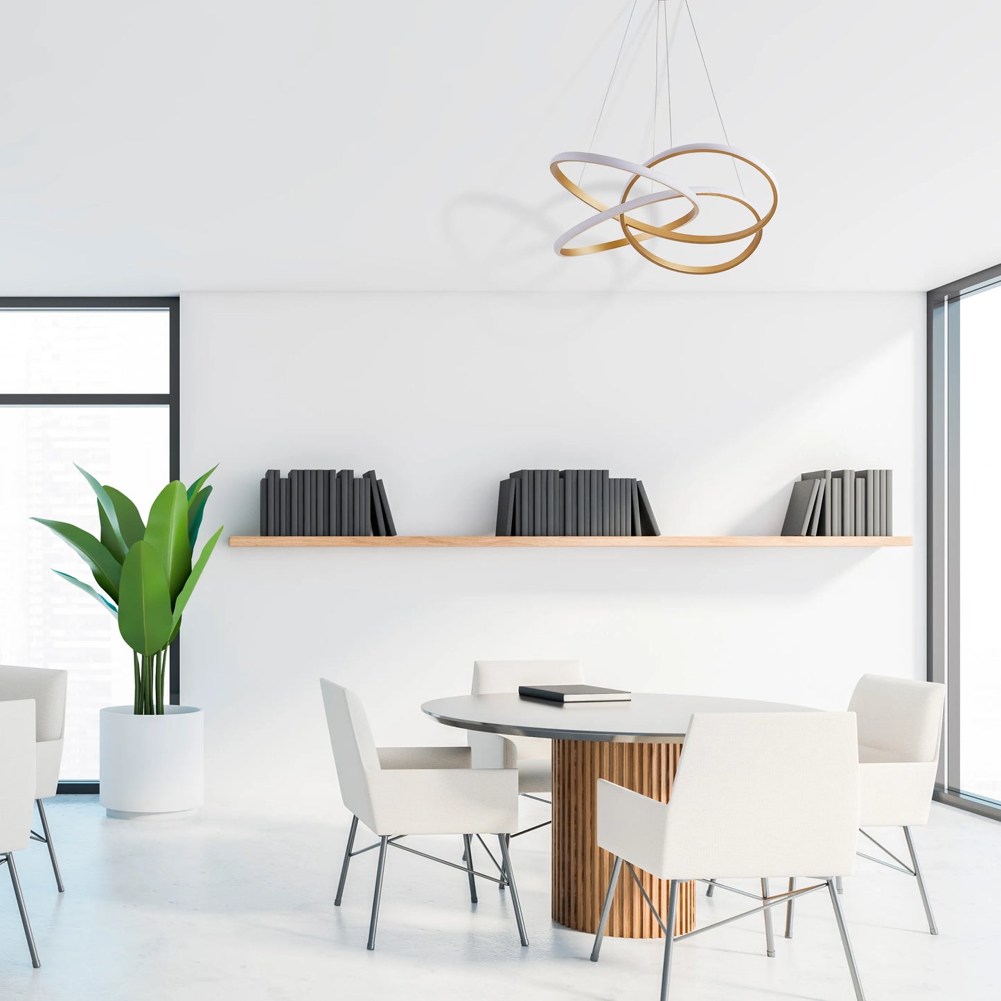 Modern, multi-ring pendant light in gold and white, casting a soft glow in a minimalist, bright white office space.