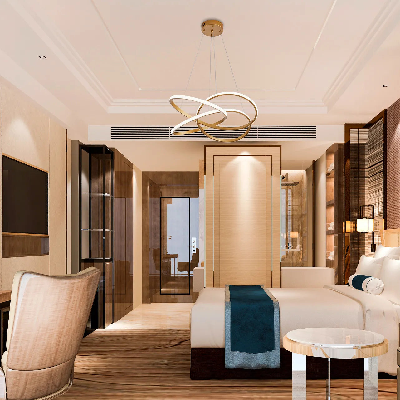 A modern statement LED chandelier with entwined golden rings, suspended above a hotel bedroom's bed.