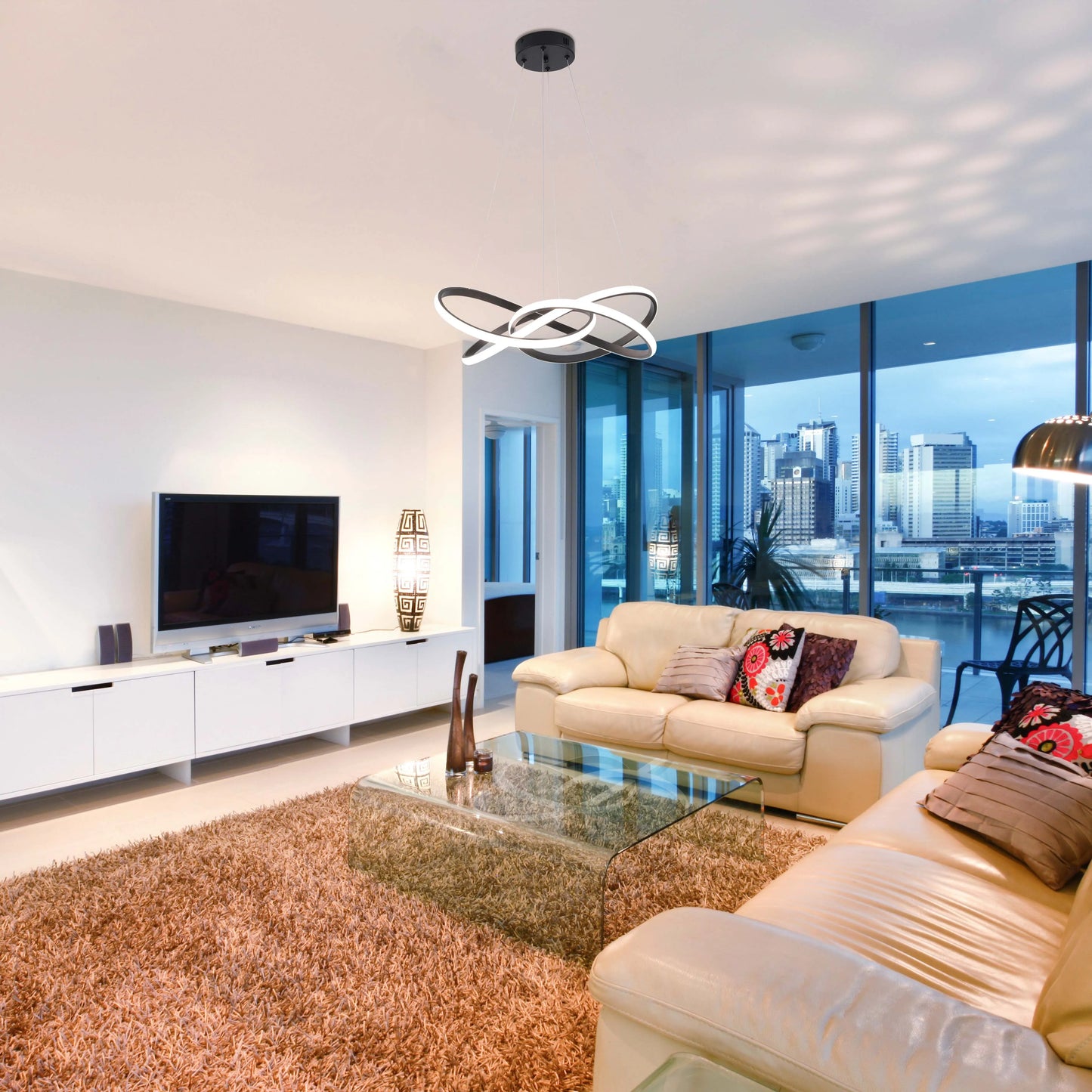 Contemporary living room featuring a striking circular pendant light in black and white, providing ambient illumination.