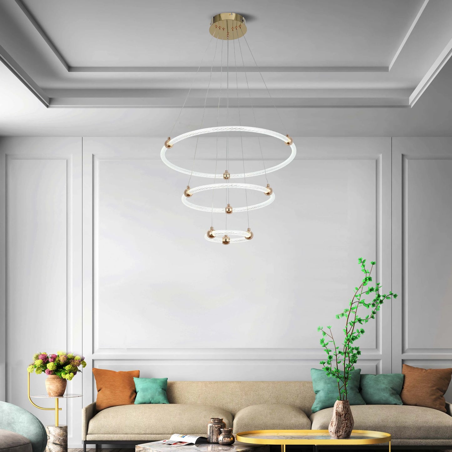 Modern chandelier with three illuminated rings, suspended from a gold ceiling plate. Provides ambient and decorative lighting.