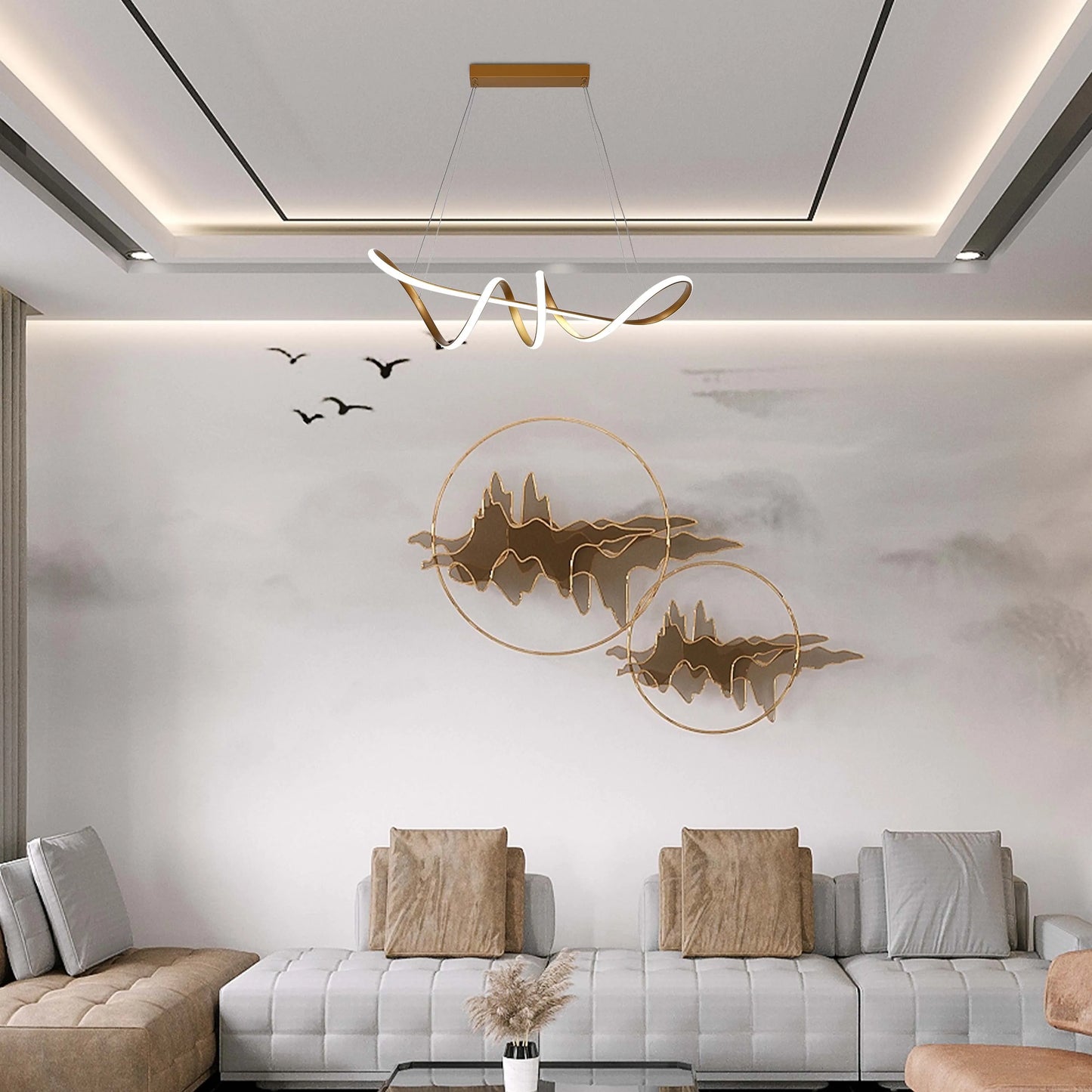 A modern living room with a statement gold and white chandelier, and recessed ceiling lights providing ambient illumination.