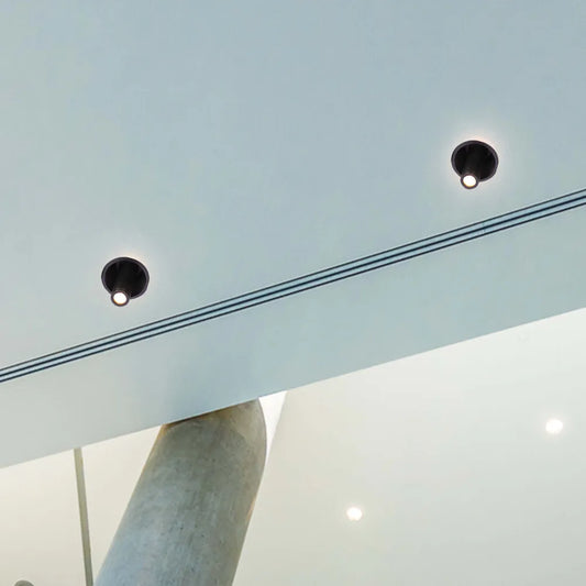 Sleek LED downlight in modern living room, enhancing minimalist decor with adjustable gimbal for focused lighting and ambiance.143-03416