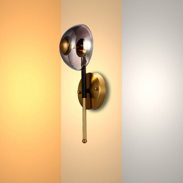 Stylish wall light with a smoked glass globe and golden accents, showcasing warm to cool colour temperature options.