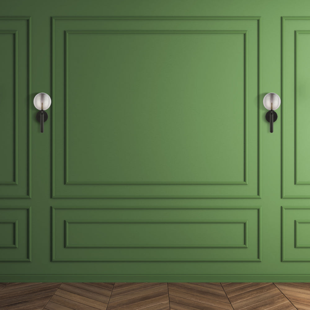 Black Striped Reeded Glass Wall Light in action on a green wall