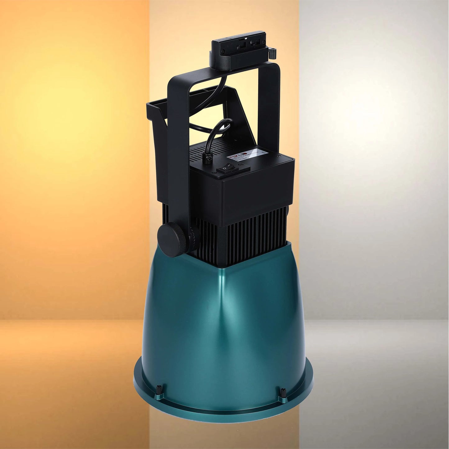 A studio LED lighting unit, black and teal, casting a soft glow. A modern and powerful luminaire.
