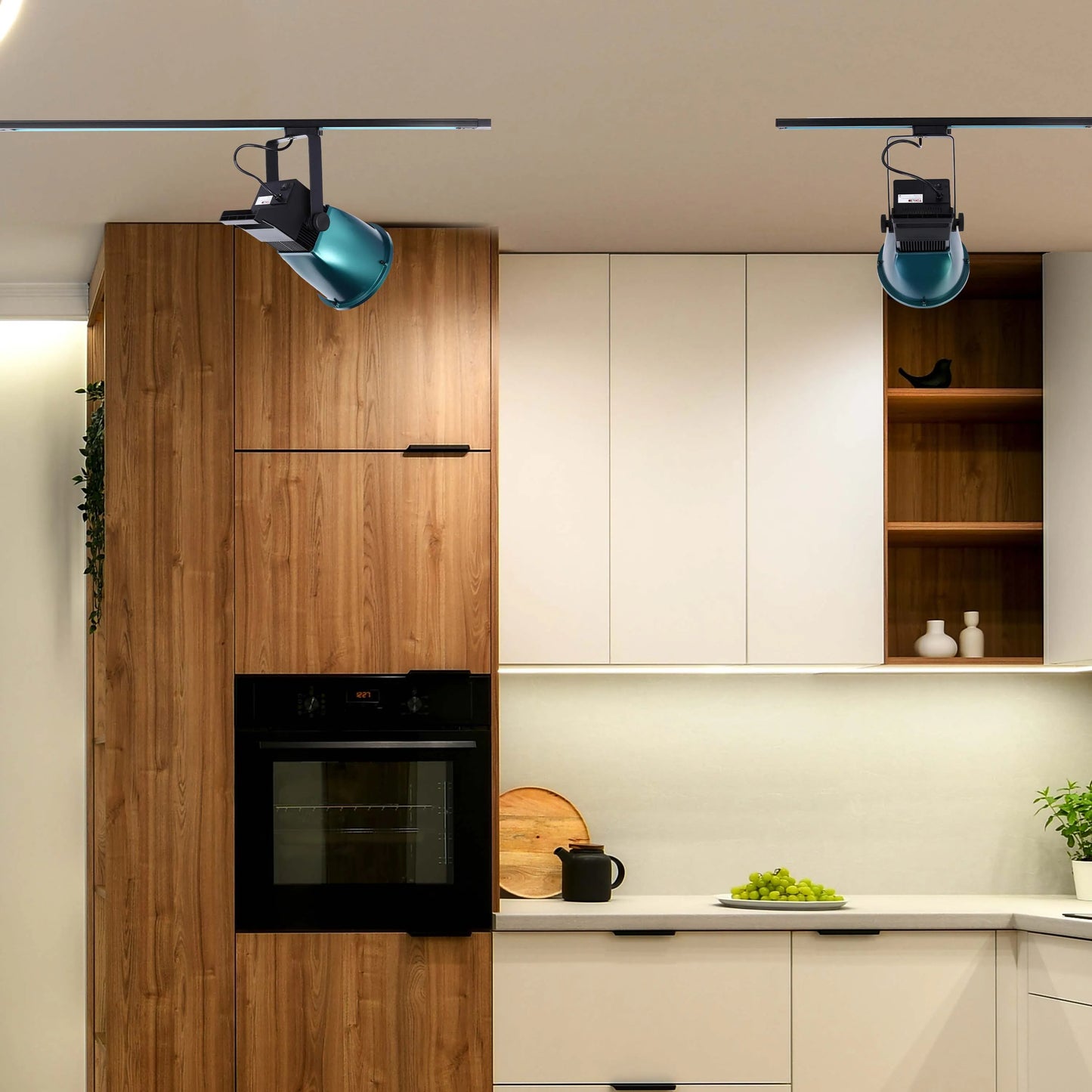Track lighting with adjustable spotlights illuminate this modern kitchen. The sleek design complements the contemporary cabinetry.