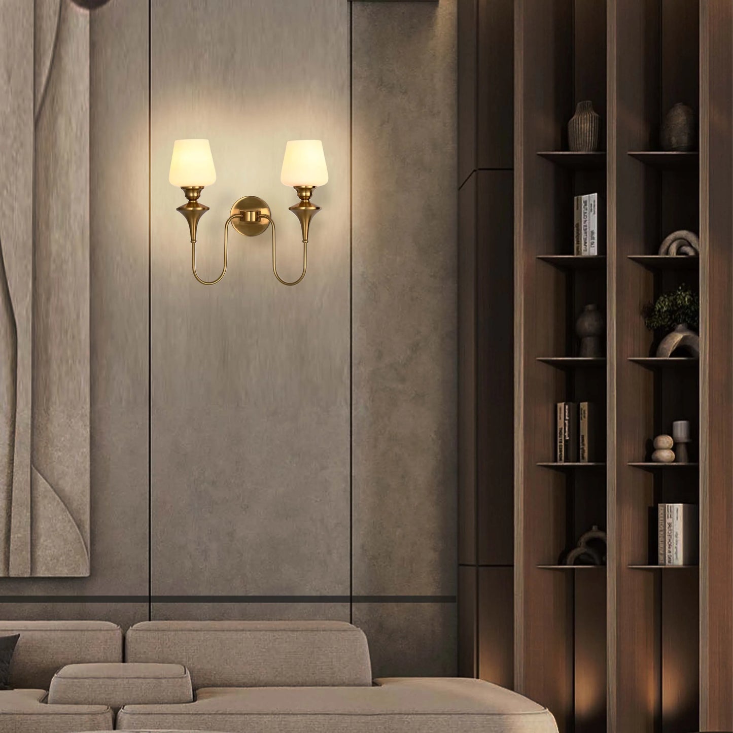 A wall mounted sconce with a polished brass finish and frosted glass shades creates warm, inviting ambient lighting.