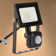 Black LED floodlight with motion sensor. Energy-efficient outdoor lighting with a sleek, modern design.