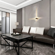 Stylish living room featuring an ambient wall light fixture and integrated LED ceiling lighting.