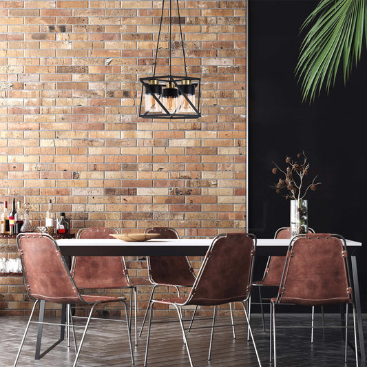 A stylish, caged pendant light in black metal with vintage-style bulbs hangs above a modern dining table, casting a warm glow.