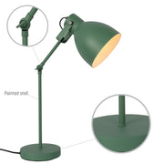 Green adjustable desk lamp with a round base, extending arm and dome-shaped lampshade. The lamp is illuminated.