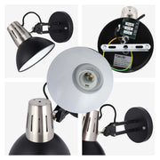 A contemporary black and silver wall lamp with an adjustable arm, offering focused lighting.