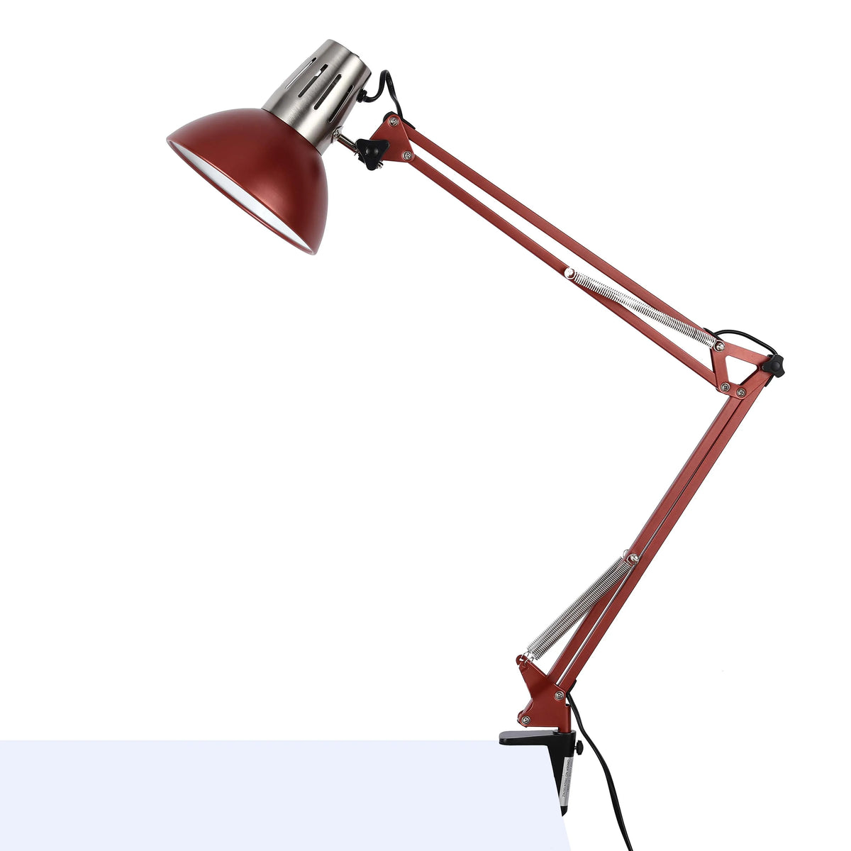 An adjustable desk lamp, with a red shade and articulated arm, clamped to a desk, providing focused task lighting.