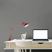 An adjustable red desk lamp illuminates a modern workspace, offering focused task lighting with a stylish design.