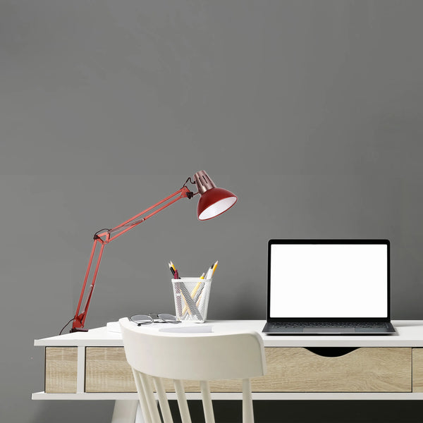 An adjustable red desk lamp illuminates a modern workspace, offering focused task lighting with a stylish design.