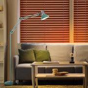 A vintage-style adjustable floor lamp illuminating a cosy living room setting with soft, diffused light and a modern table lamp.