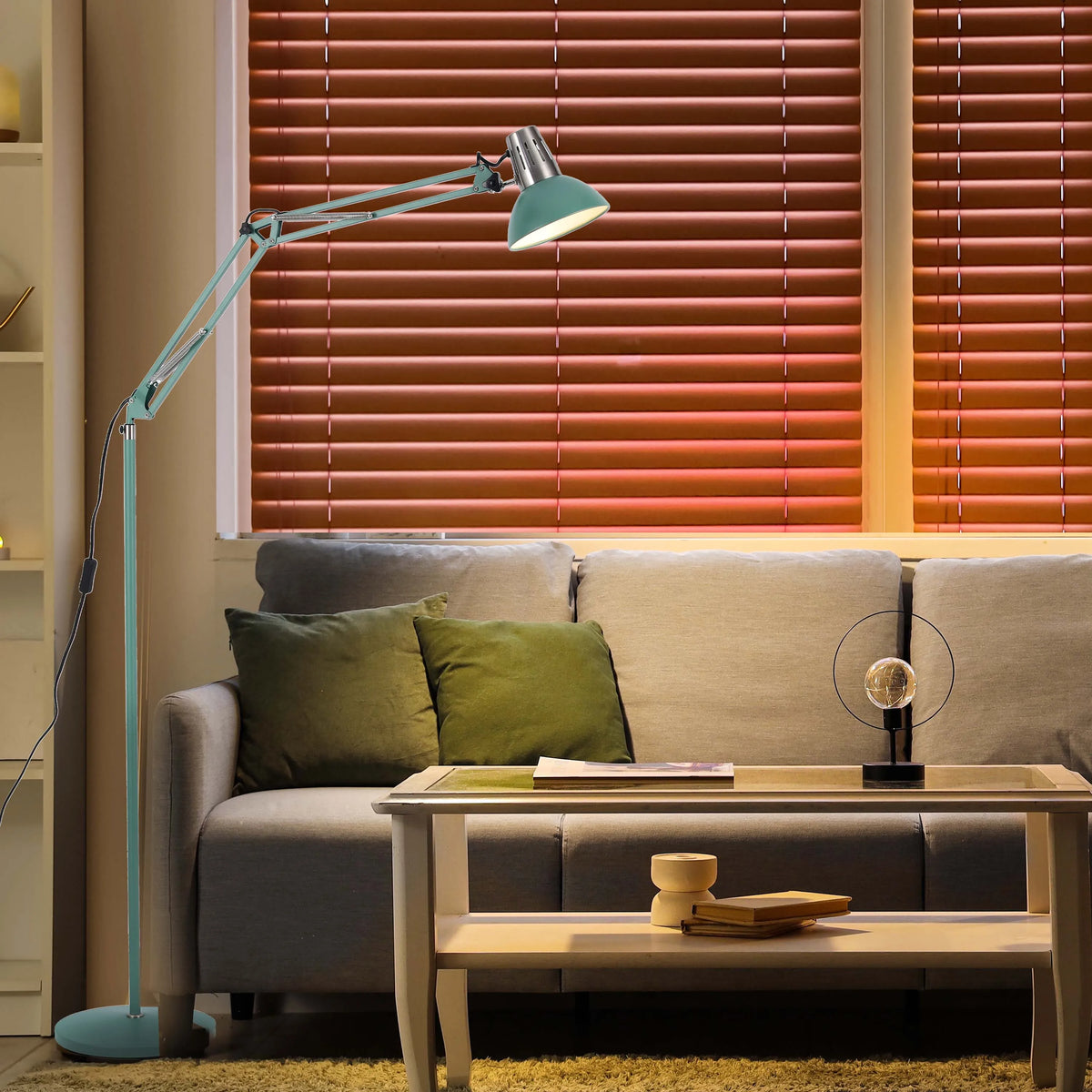 A vintage-style adjustable floor lamp illuminating a cosy living room setting with soft, diffused light and a modern table lamp.