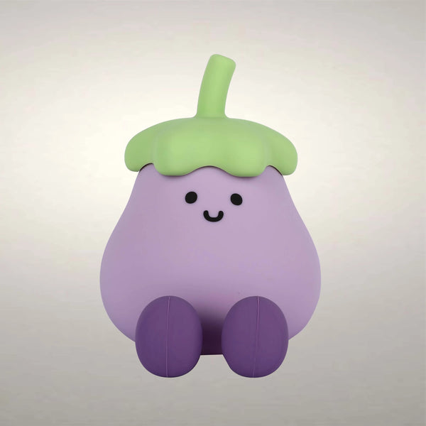 Soft, even lighting highlights the cute, cartoonish design of a smiling, purple eggplant with green top and darker purple legs.