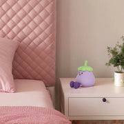 Soft, diffused lighting illuminates this bedroom, creating a warm and inviting atmosphere, highlighting the whimsical bedside lamp.