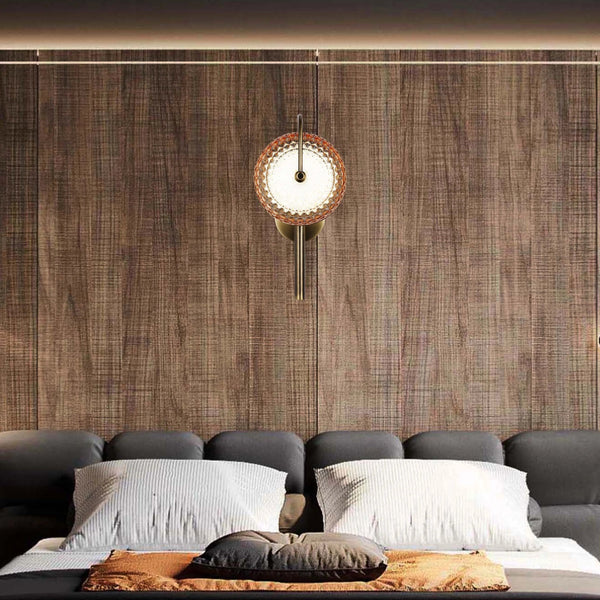 A stylish wall light with an intricate, patterned shade provides a warm and ambient glow in this bedroom setting.