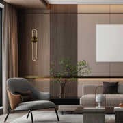 A sleek wall light emits a warm, modern glow, complementing the room's elegant design.