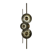 A modern wall light fixture with several metallic, circular lights running down a bar, creating a sophisticated ambiance.